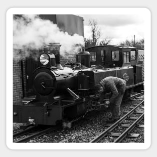 Engineer attending to a steam train on the Bure Valley Railway Sticker